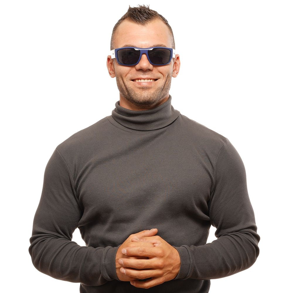 Person wearing Tommy Hilfiger blue unisex sunglasses with blue frames, showcasing trendy eyewear style.