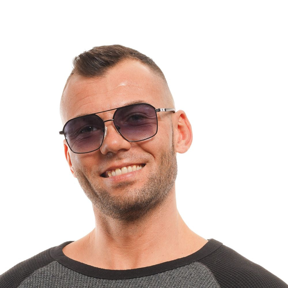 Man wearing Guess black aviator sunglasses with blue mirrored lenses and full-rim black metal frame.