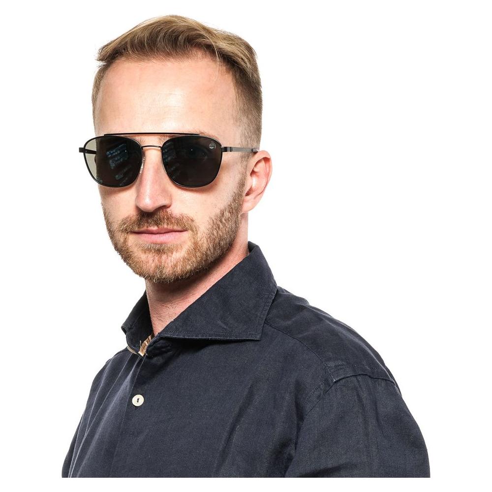 Man wearing Timberland black metal frame sunglasses with blue polarized lenses, styled in an oval shape, offering 100% UVA & UVB protection.