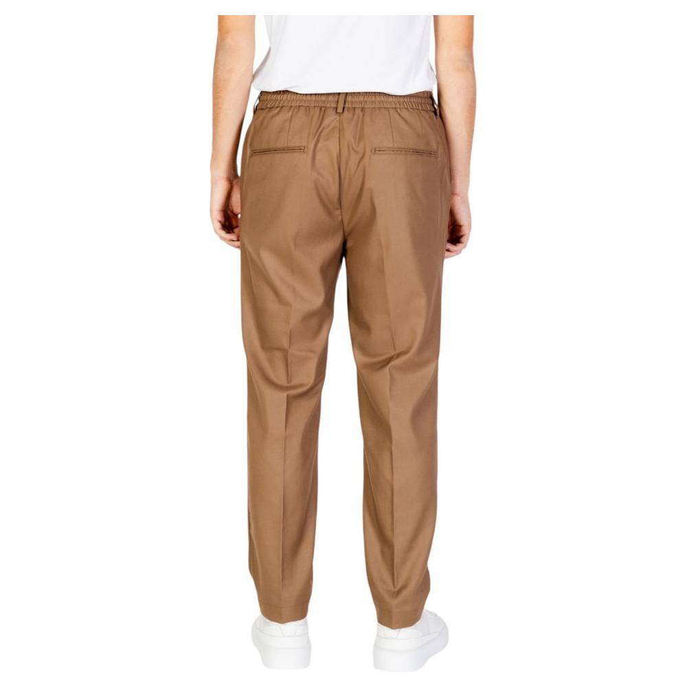 Back view of Hamaki-Ho beige men's pants, polyester blend for fall and winter, showing elastic waist and relaxed fit.