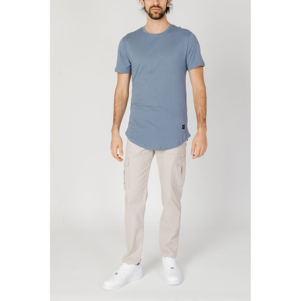 Man wearing Only & Sons beige cotton jeans with blue shirt, ideal for spring summer collection, featuring 98% cotton.