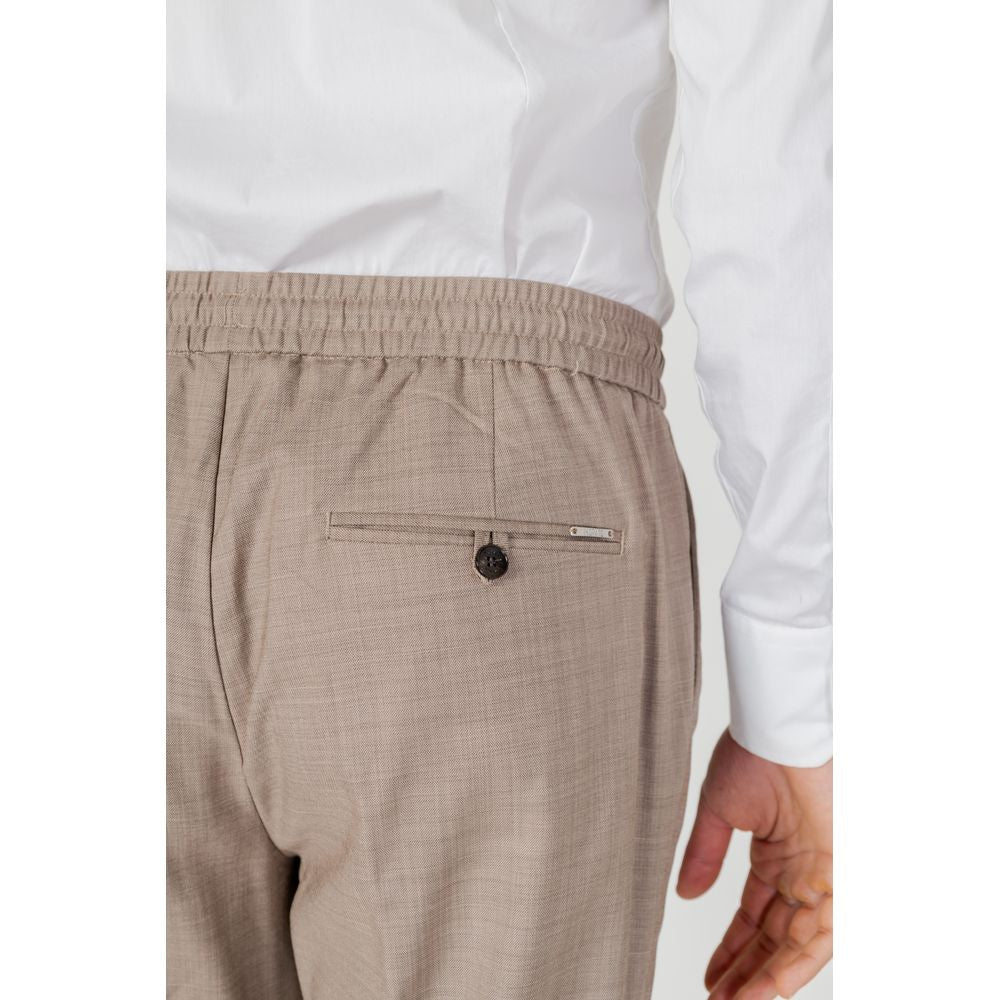 Back view of Antony Morato beige polyester men's pants from spring/summer collection, featuring elastic waistband and buttoned pocket.