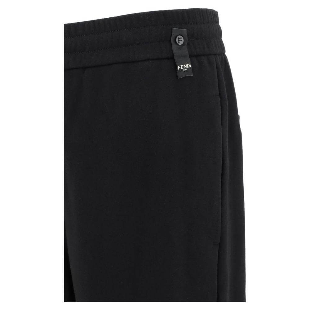 Close-up of Fendi sweatpants featuring an elastic waistband and iconic logo detail for stylish comfort.