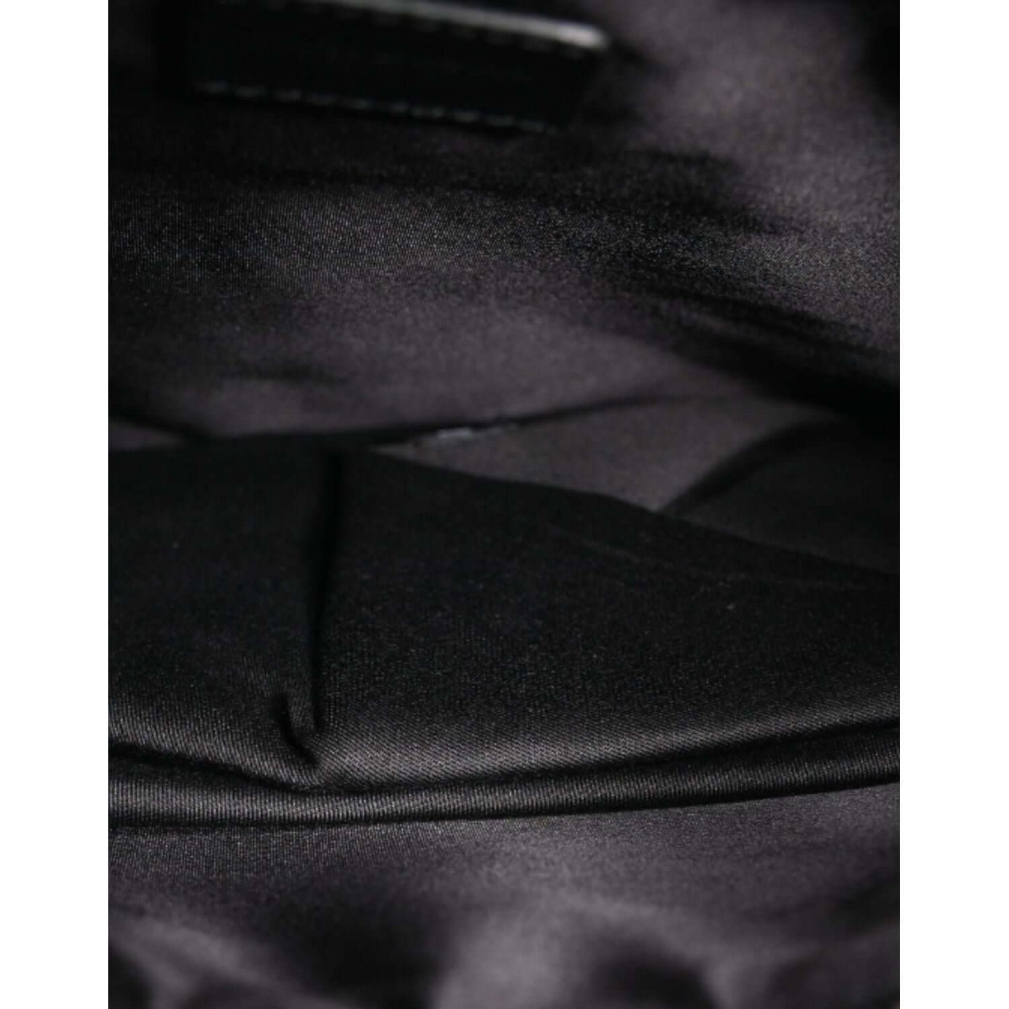 Interior view of Dolce & Gabbana black clutch showcasing its nylon inner lining and fine craftsmanship.