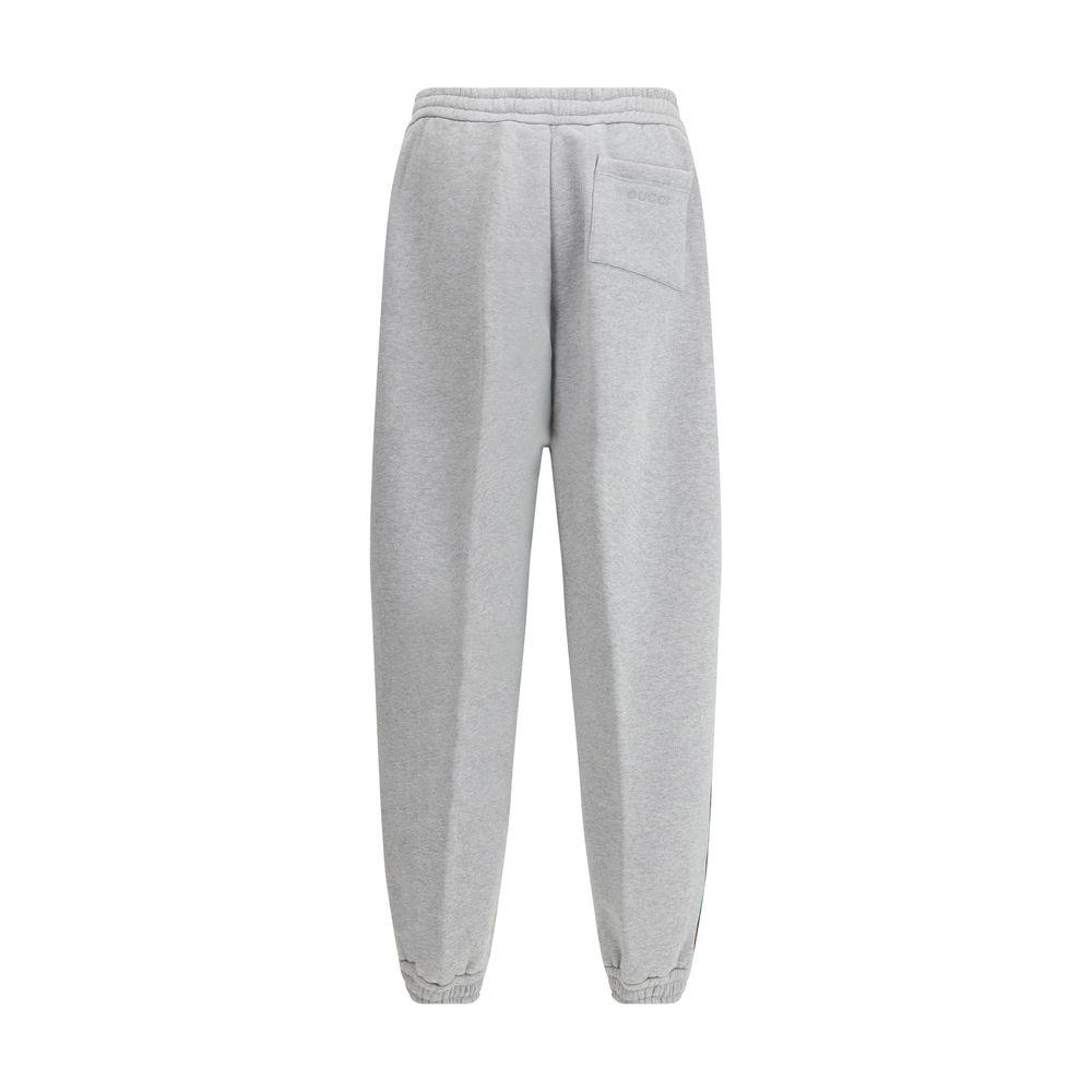 Back view of Gucci colored side bands sweatpants with monogram patch and elastic waist.