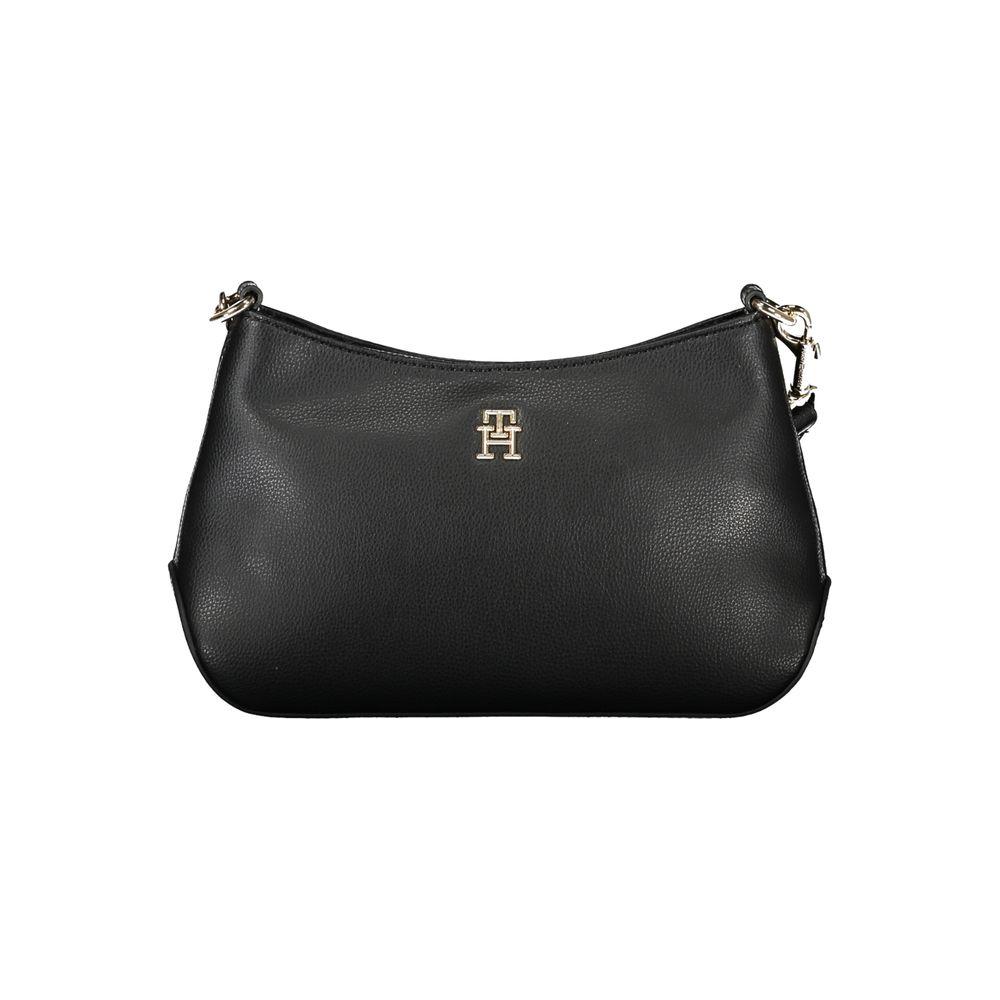 Tommy Hilfiger black polyester handbag with adjustable strap, internal pocket, zip closure, and logo on the front.