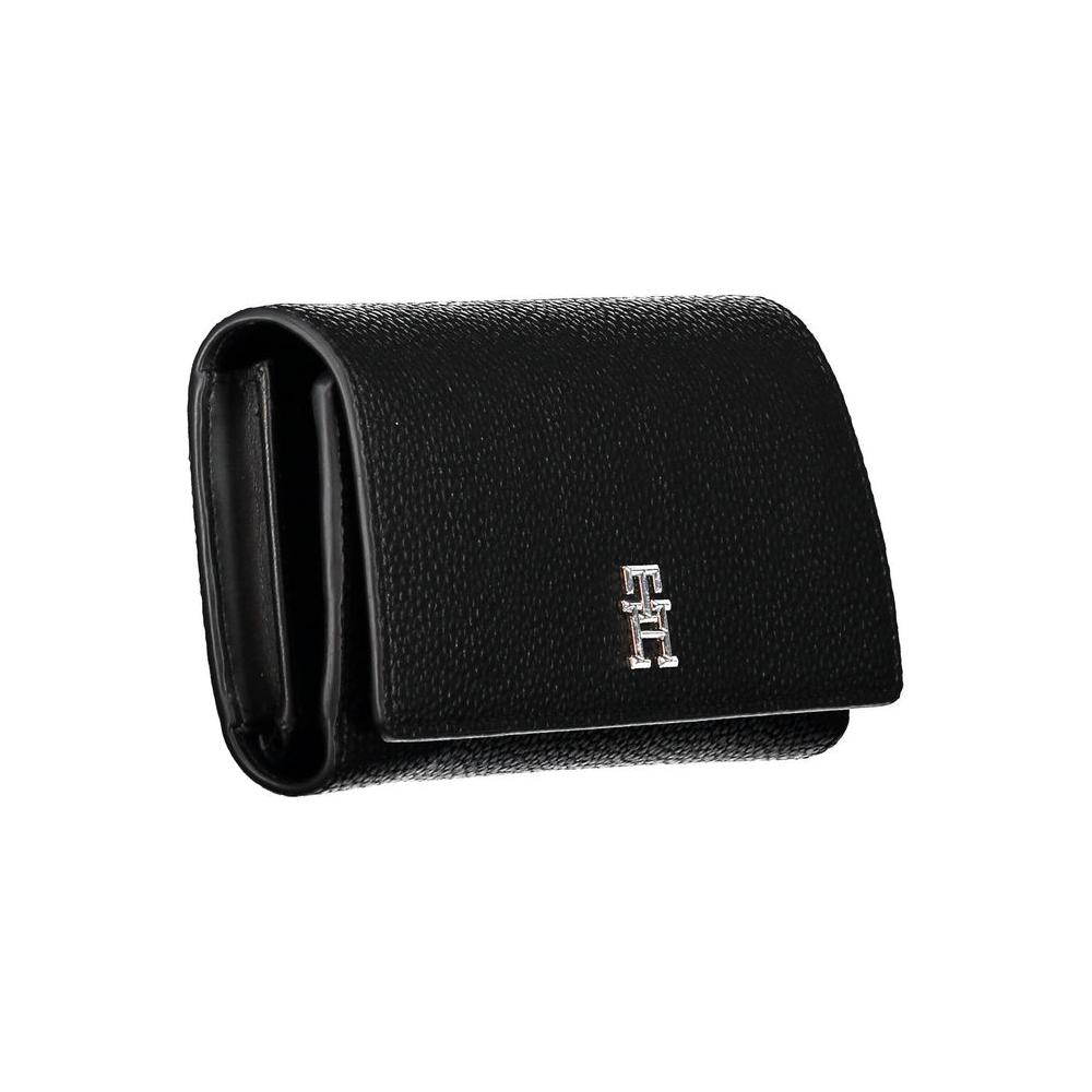 Tommy Hilfiger black polyethylene wallet for women with iconic logo, zip and snap closure, sleek design, and functional compartments.