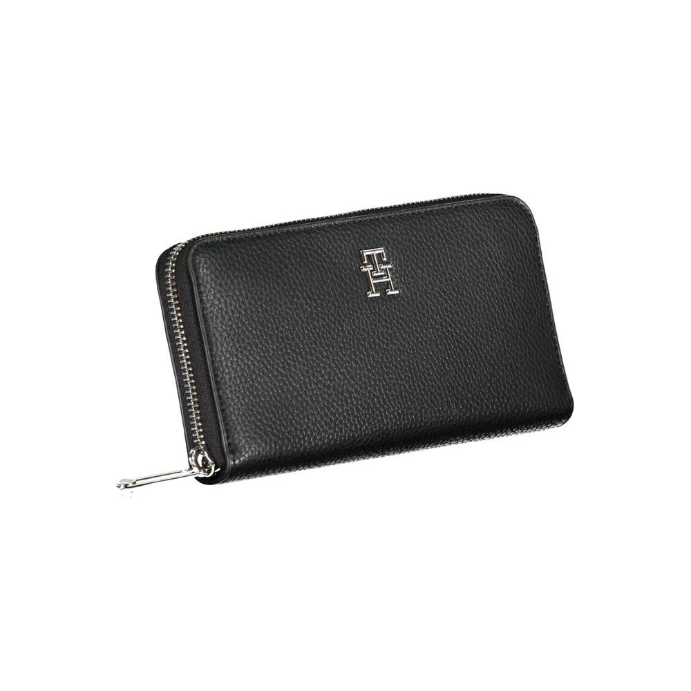 Tommy Hilfiger sleek black multipurpose wallet with zip closure and logo accent.