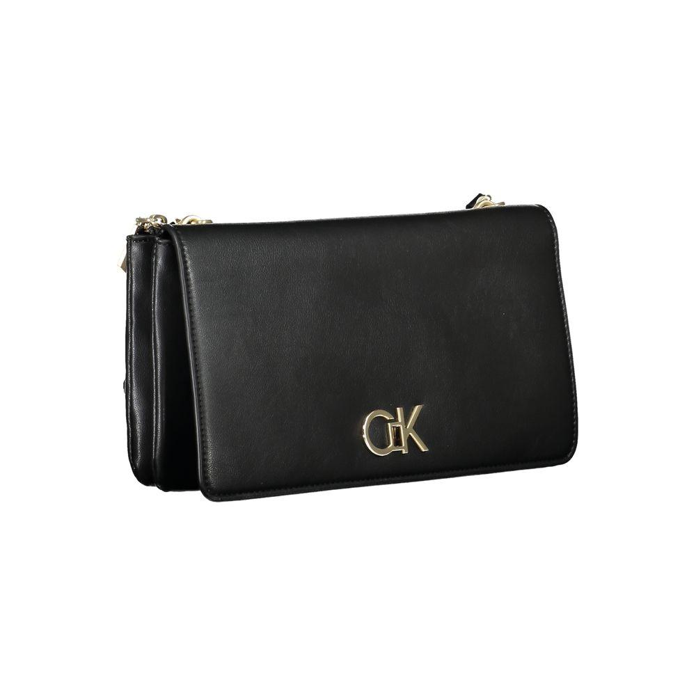 Calvin Klein black polyester handbag with adjustable strap, two compartments, internal pocket, and zip closure, featuring logo.