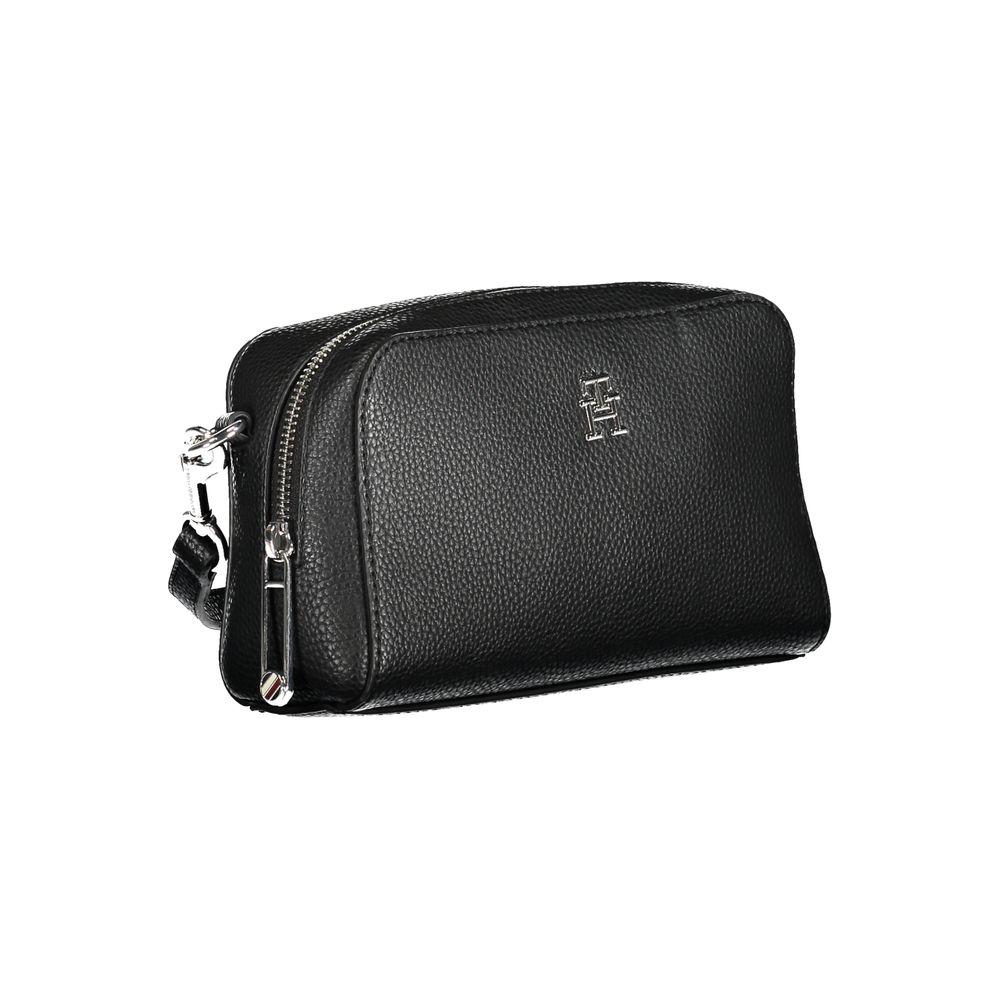 Tommy Hilfiger black handbag with adjustable and removable shoulder strap, zip closure, and logo detail.