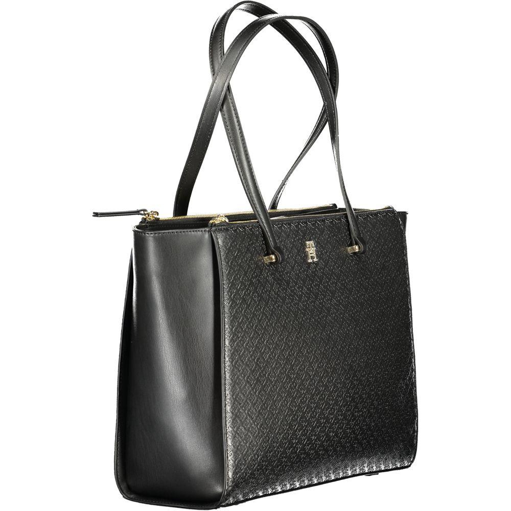 Tommy Hilfiger black polyethylene women’s handbag with 2 handles, featuring a bold pattern and secure zip closure.