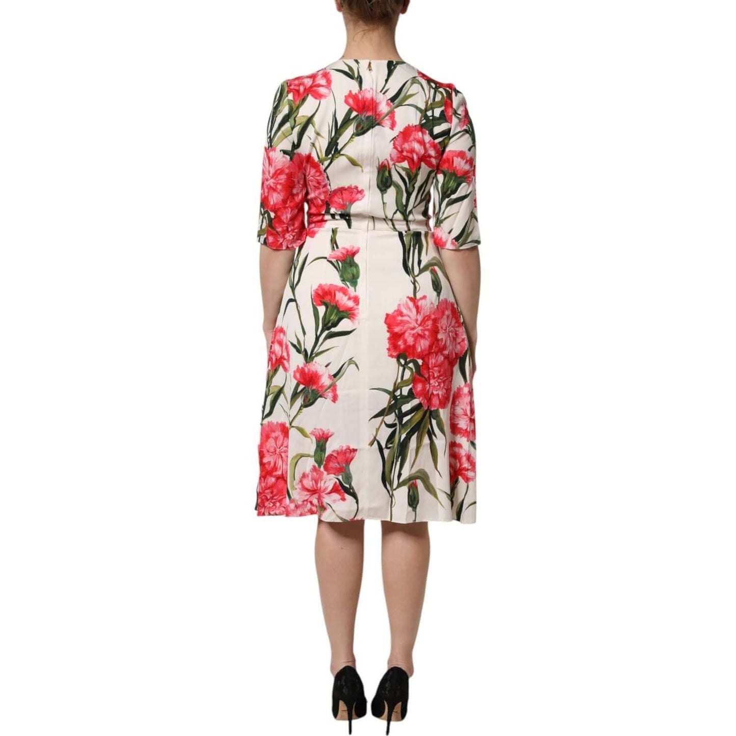 Back view of Dolce & Gabbana pink floral print sheath dress with short sleeves and zipper closure, model wearing heels.