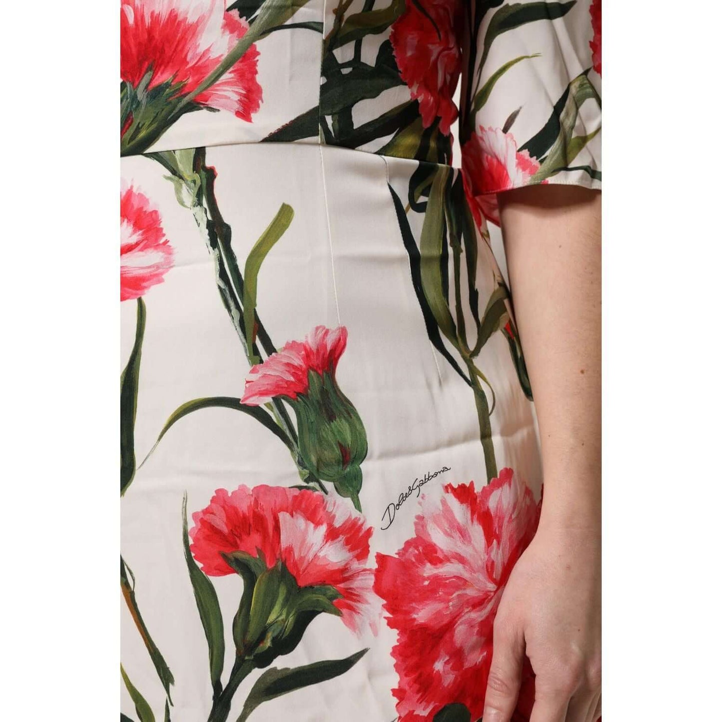Close-up of Dolce & Gabbana pink floral print silk sheath dress with short sleeves, showcasing elegant craftsmanship and exclusive design.