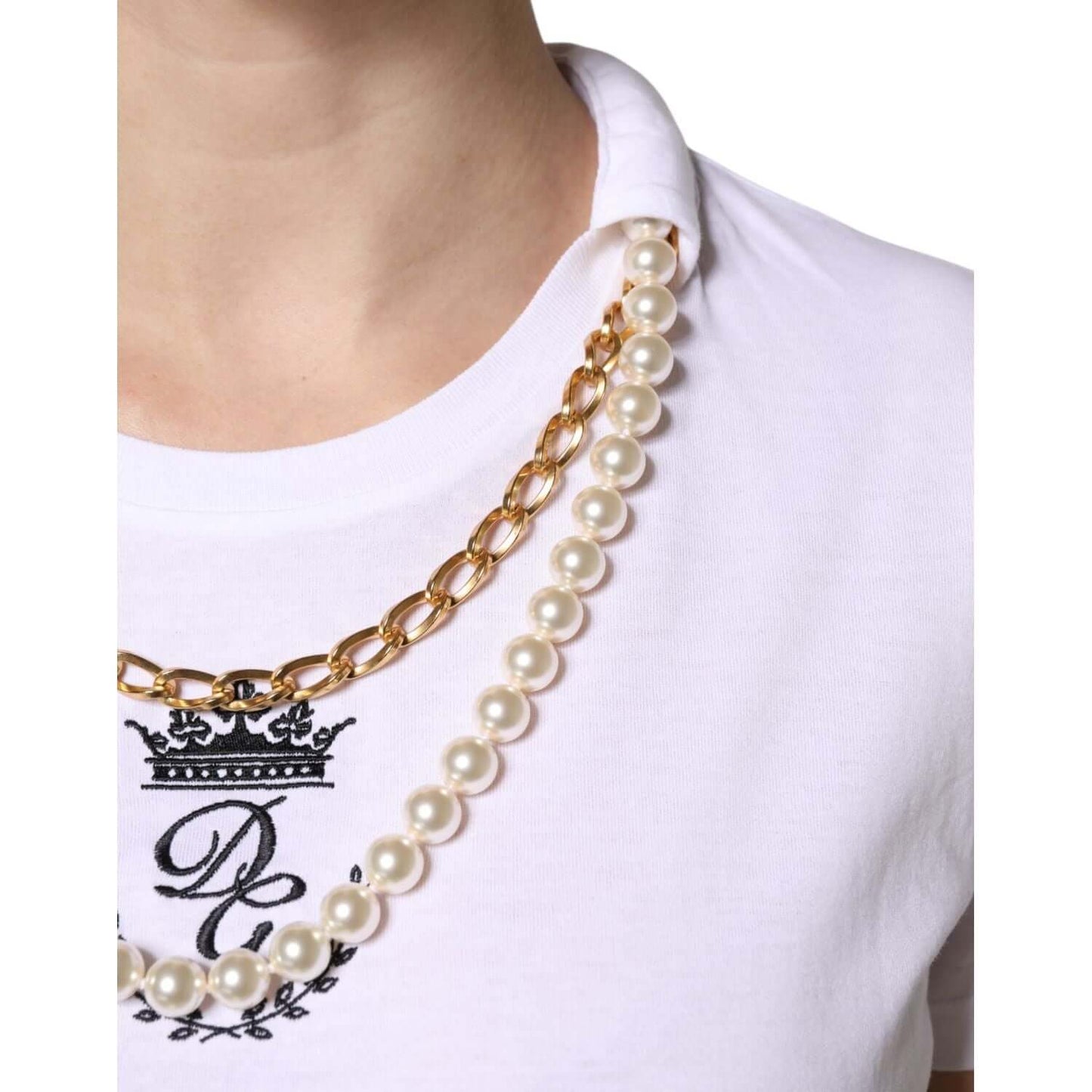 Close-up of Dolce & Gabbana white chain pearl round neck T-shirt with embroidered logo, showcasing luxury fashion details.