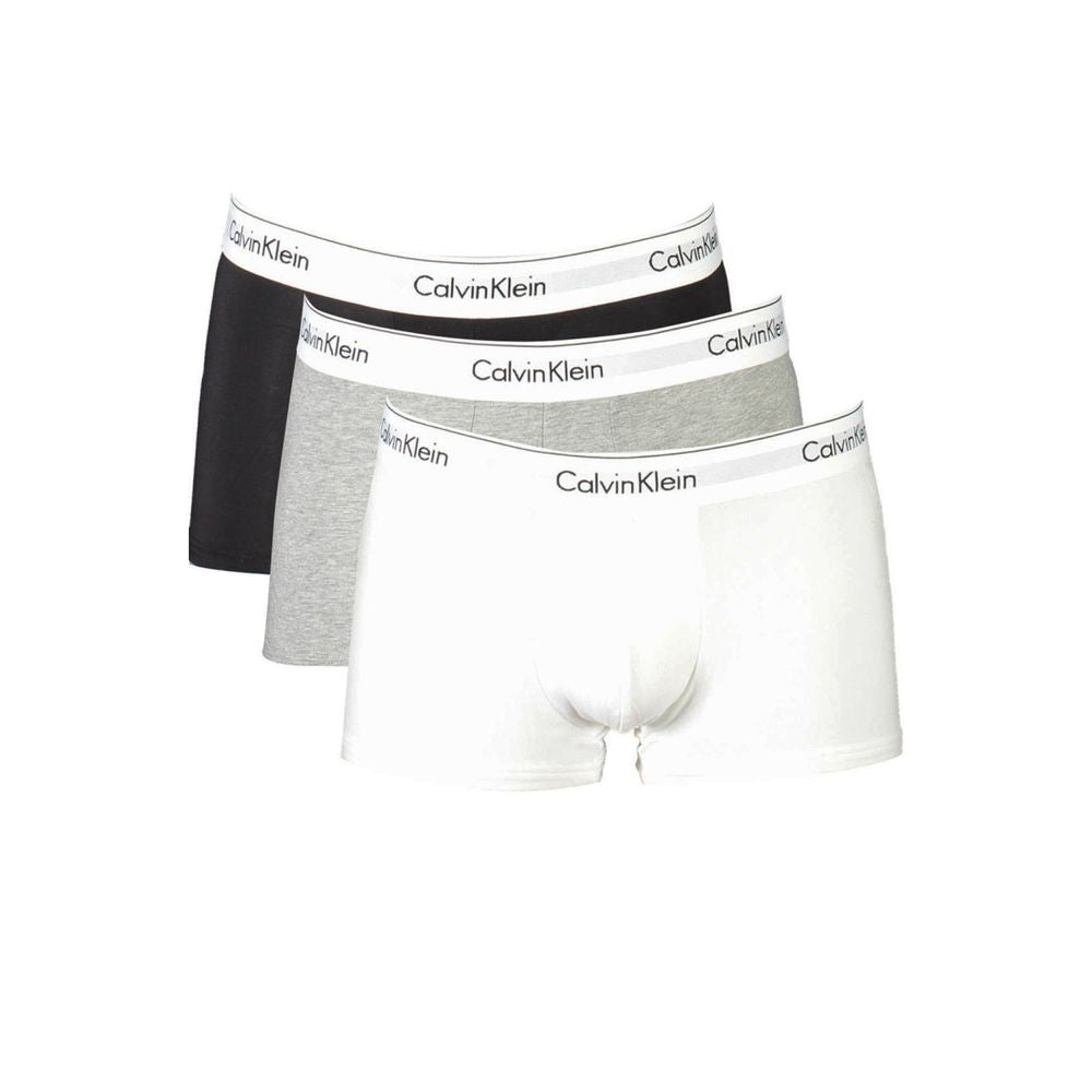 Calvin Klein tri-pack boxer shorts in black, grey, and white with logo waistband, made from sustainable cotton blend for comfort.