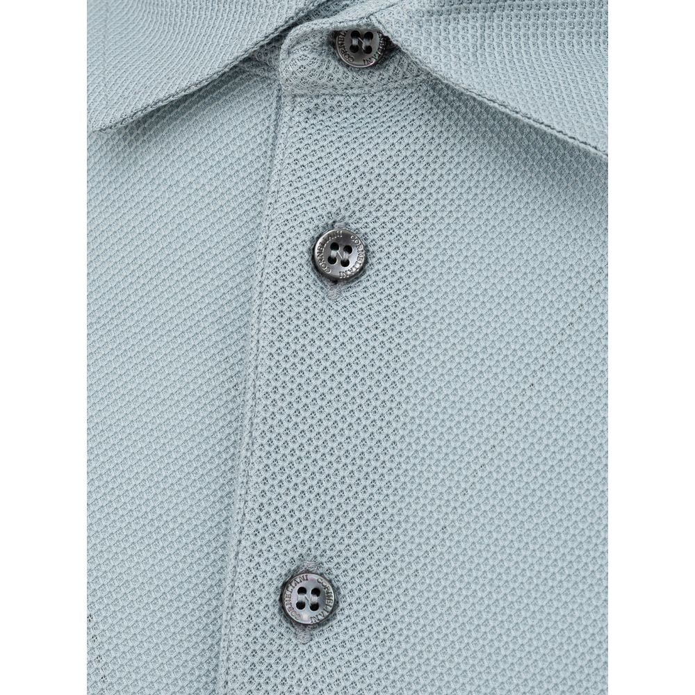 Close-up of Corneliani blue cotton polo shirt with classic collar and buttons, made in Italy, showcasing textured piquet fabric.