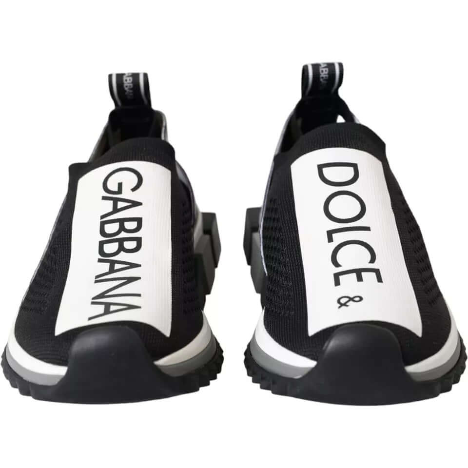 Dolce & Gabbana Sorrento black and white slip on sneakers with logo print, fabric pull strap, and black decorative rubber sole.