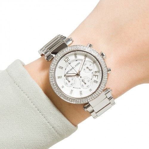 Silver Michael Kors MK5353 watch with crystal bezel on wrist, elegant and stylish timepiece for women.