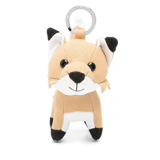 Maison Kitsuné Fox bag charm with light beige fox motif, pop-up animal ears, and engraved logo keyring attachment.