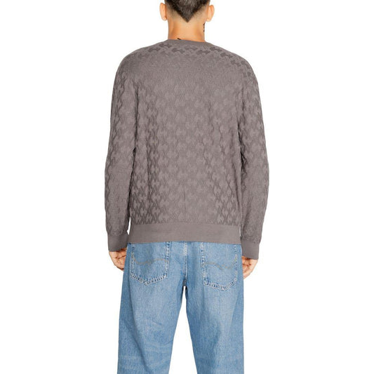 Back view of man wearing Armani Exchange gray viscose knit t-shirt, part of men's fall/winter collection, paired with blue jeans.