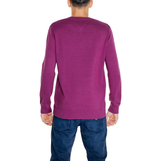 Back view of a man wearing a Tommy Hilfiger purple organic cotton sweater from the autumn/winter collection, paired with jeans.
