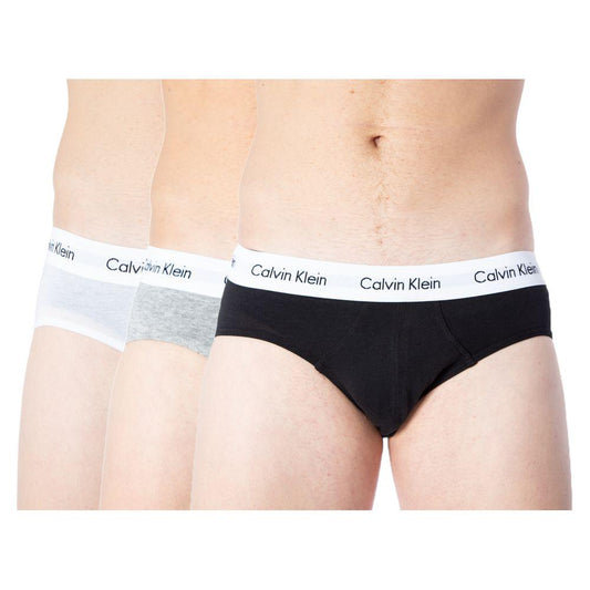 Three pairs of Calvin Klein men's cotton briefs in white, gray, and black with branded waistbands.