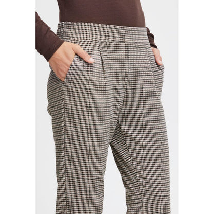 Woman wearing ICHI Beige Polyester Casual Pants with flat waistband and tapered cut.