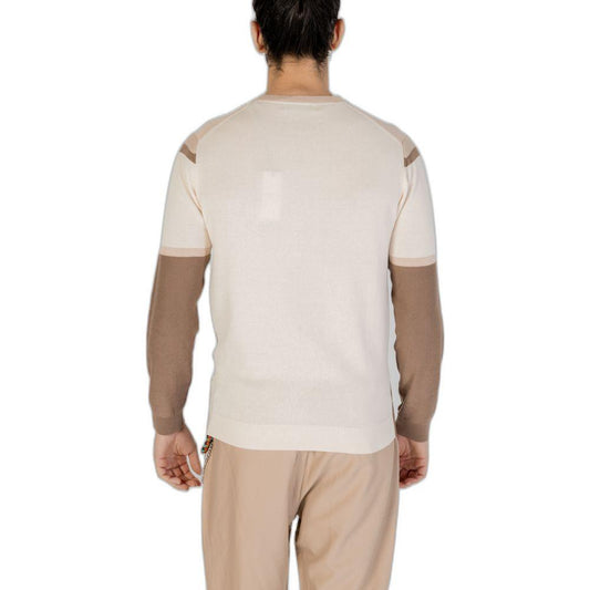 Back view of a person wearing a beige and brown long-sleeve shirt and pants, showcasing the design and fit from the rear.