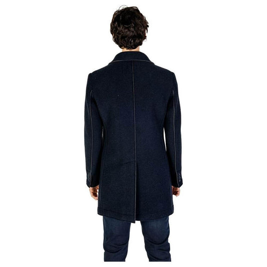 Rear view of man wearing Hydra Clothing blue wool jacket, part of men's fall/winter collection, made of wool and synthetic fibers.