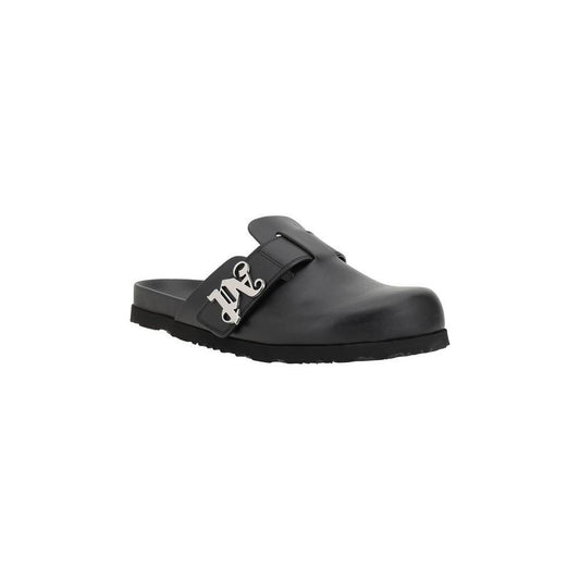 Palm Angels leather mules with round toe, slip-on design, and branded logo plaque on wide strap, offering comfort and modern style.