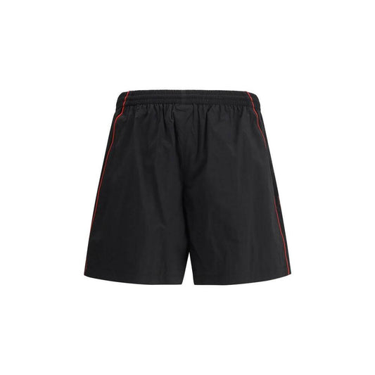Black Balenciaga tracksuit shorts with elasticized waist and side pockets featuring iconic monogram stitching.
