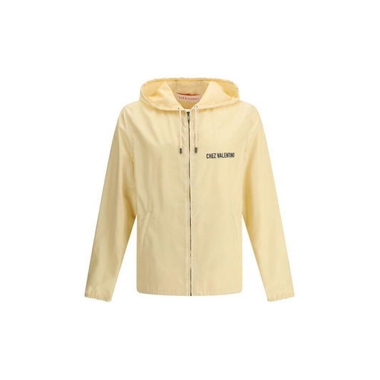 Valentino waterproof jacket with monogram, featuring a zipper closure, adjustable hood, and side pockets. Stylish and functional rain protection.