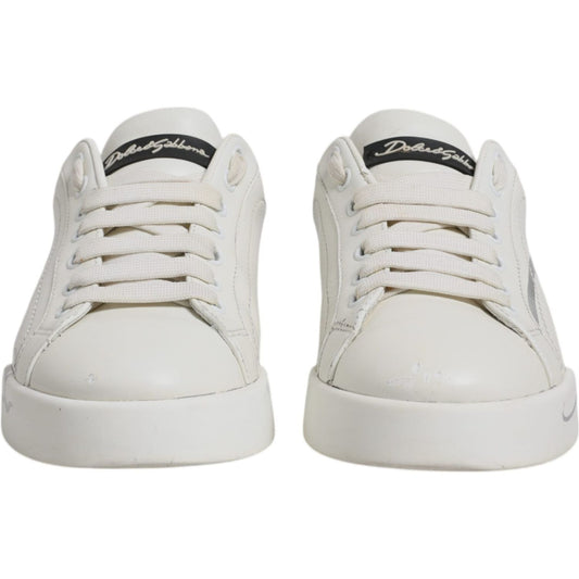 Dolce & Gabbana Portofino sneakers, white with black logo, lace-up, round toes, made of calfskin leather with rubber soles, front view.