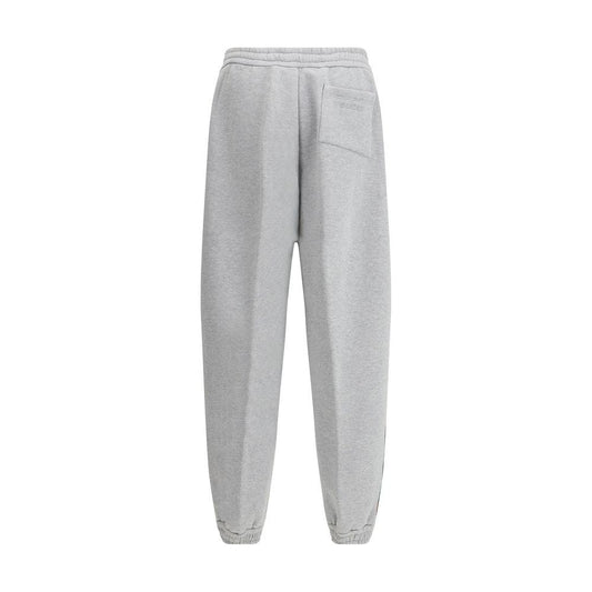 Back view of Gucci colored side bands sweatpants with monogram patch and elastic waist.