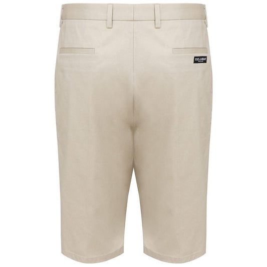 Back view of beige Dolce & Gabbana Bermuda shorts with logo, side and back pockets, button and zip closure, cotton blend.