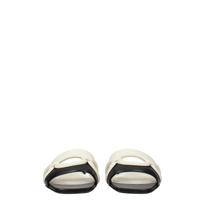 Valentino Garavani Black Leather Slippers with open toe and ivory detail, casual style with flat leather sole.