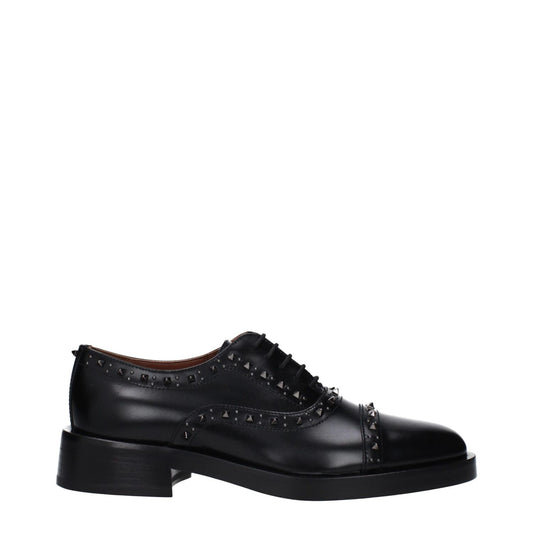 Valentino Garavani Black Leather Oxfords And Derbies with studs, lace-up design, mid heel, round toe, and leather sole.