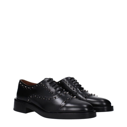 Valentino Garavani Black Leather Oxfords And Derbies with studs, lace-up design, round toe, mid heels, black leather sole.