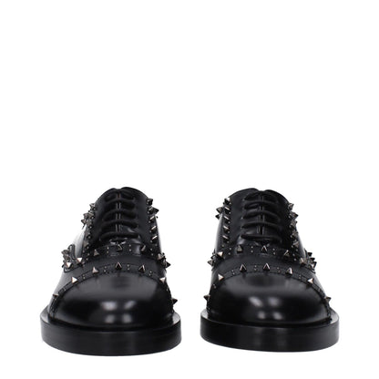 Valentino Garavani Black Leather Oxfords And Derbies with studs, lace-up design, casual style, leather sole, mid heels, and round toe.