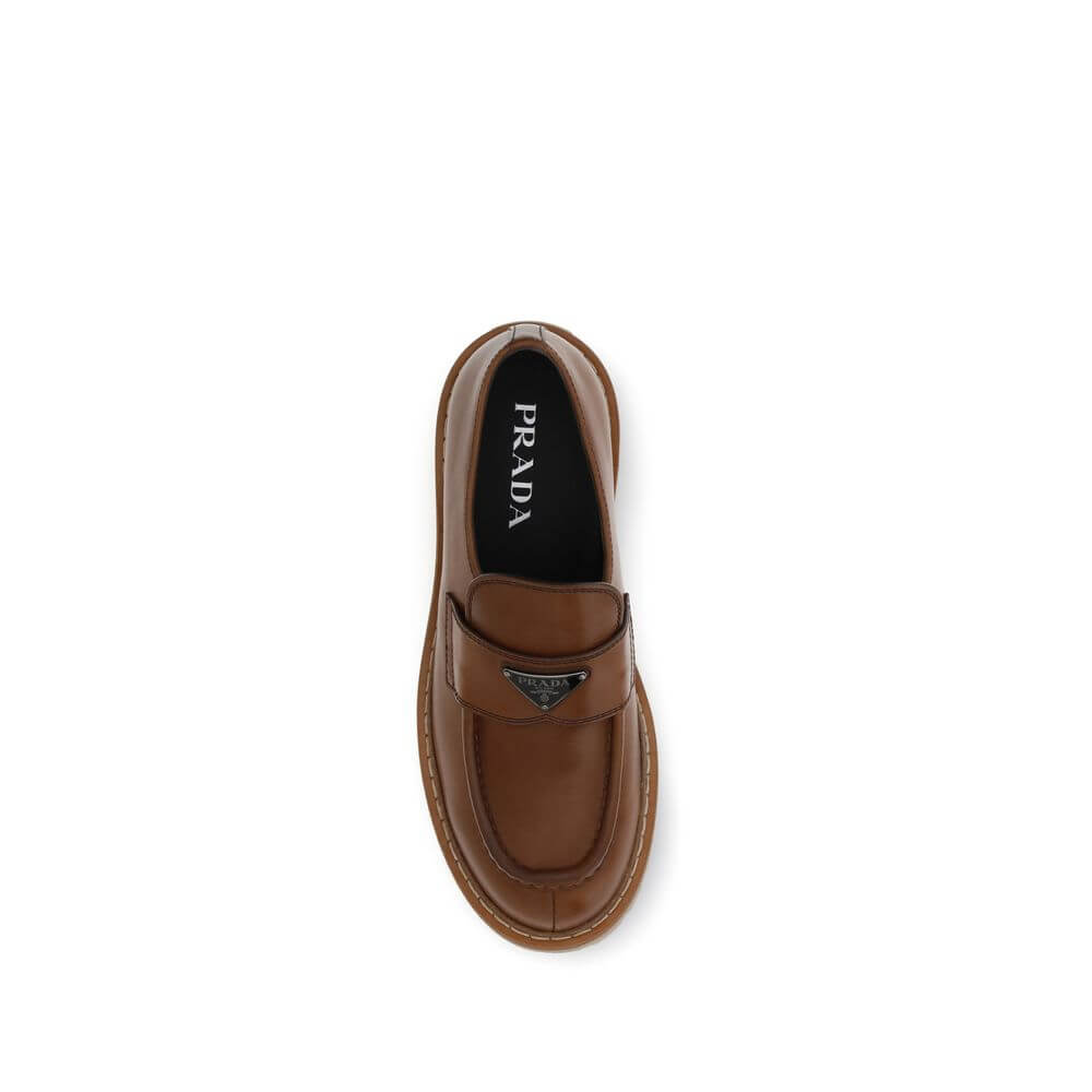 Top view of Prada Brown Calf Leather Bos Taurus Slip-On Loafers with patent-effect leather and rugged carrarmate sole.