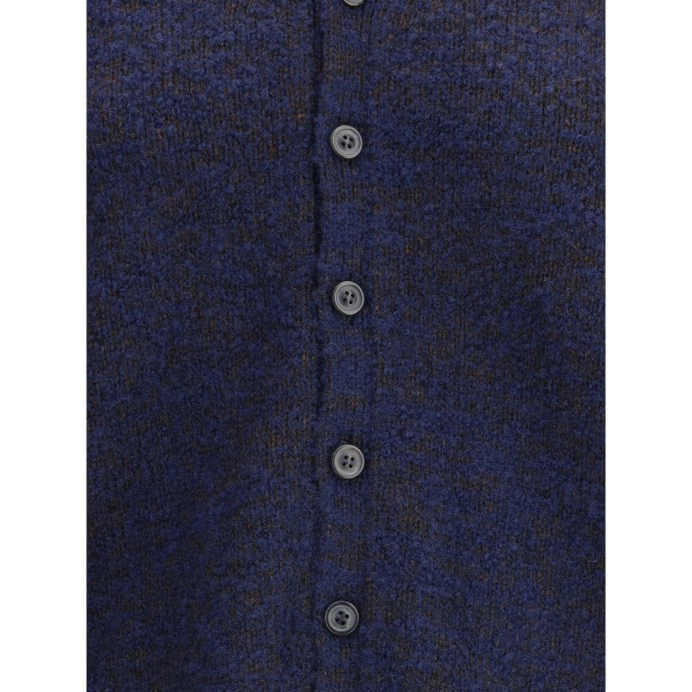 Margiela Blue Wool Cardigan with tone-on-tone buttons and ribbed edges, showcasing refined essentiality and characteristic stitches.