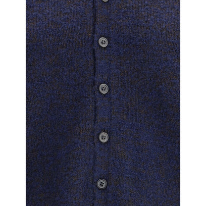 Margiela Blue Wool Cardigan with tone-on-tone buttons and ribbed edges, showcasing refined essentiality and characteristic stitches.