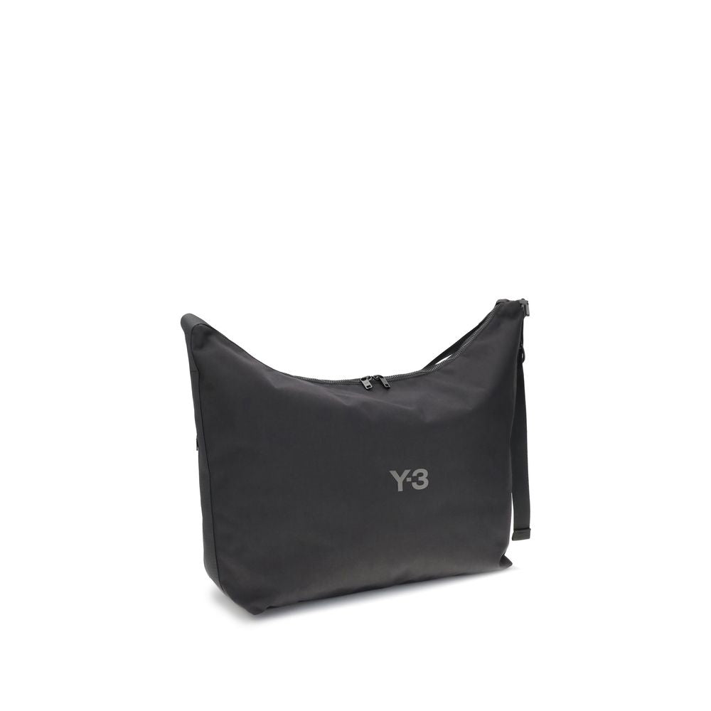 Y-3 Black Polyamide Shoulder Bag with large compartment and adjustable strap, featuring a zippered closure and printed logo detail.