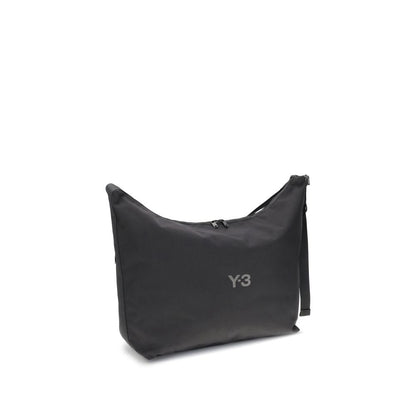 Y-3 Black Polyamide Shoulder Bag with large compartment and adjustable strap, featuring a zippered closure and printed logo detail.