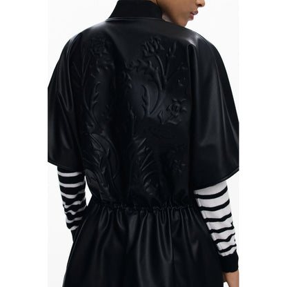 Back view of Desigual Black Polyethylene Women Poncho with embossed floral design.