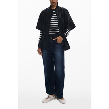 Model wearing Desigual Black Polyethylene Women Poncho with stripes and jeans, featuring a drawstring waist and embossed print.