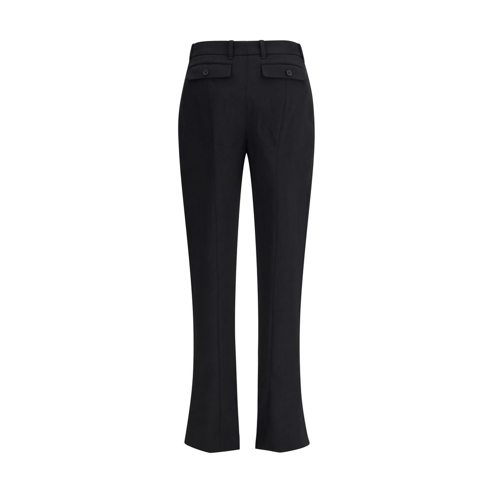 Alexander McQueen Black Wool Dress Pants with pleated tapered legs and back flap pockets, showcasing refined elegance and tailoring.