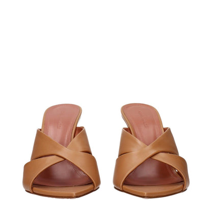 Amina Muaddi Brown Leather Stiletto Heel Sandals front view with criss-cross strap design.