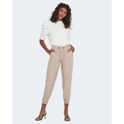 Woman wearing Only Beige Viscose Casual Pants with elastic cuffs and a white top, demonstrating a stylish and comfortable outfit.