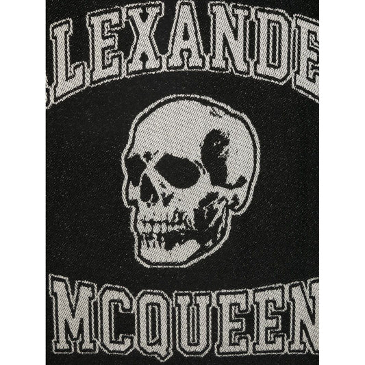 Close-up of Alexander McQueen Logo wool scarf featuring skull print and logo details in black wool.